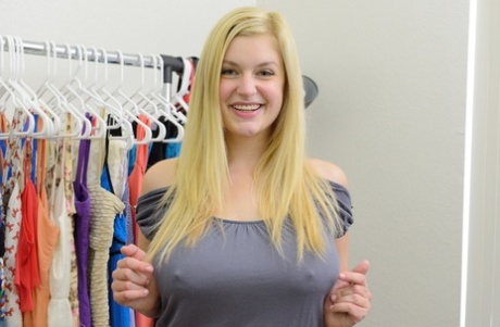 Busty blonde Danielle flashes her big tits and bald pussy in the uniform shop