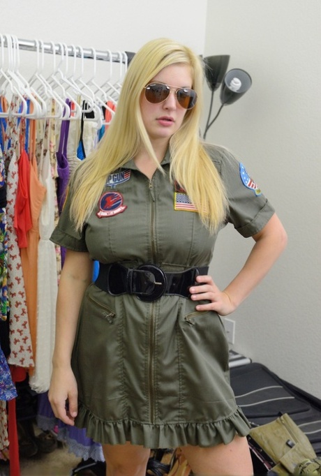 Busty blonde Danielle flashes her big tits and bald pussy in the uniform shop