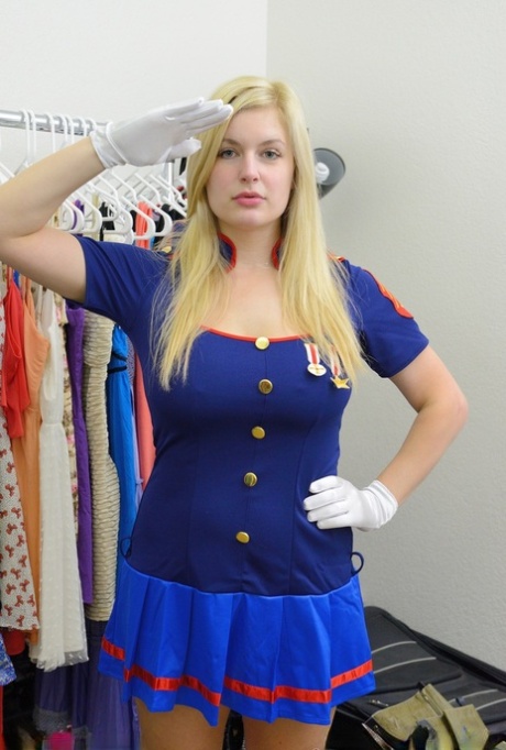 Busty blonde Danielle flashes her big tits and bald pussy in the uniform shop