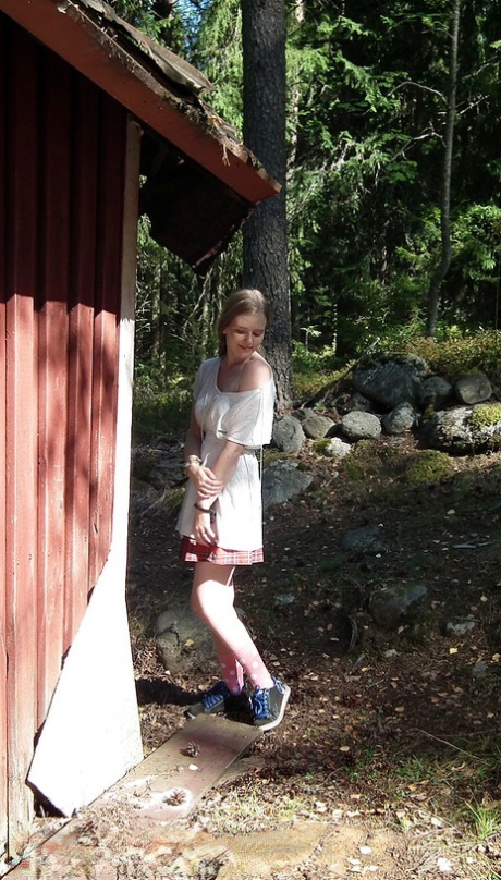 Solo girl shows her tits and twat while forcing entry into abandoned cabin