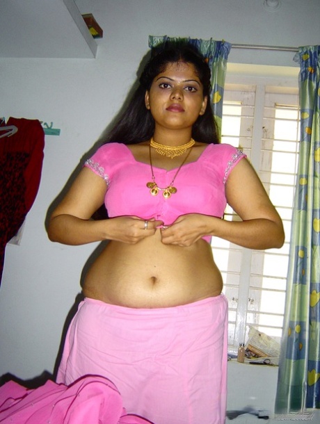 Plump Indian girl Neha gets totally naked on her bed in solo action