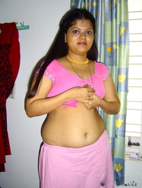 Plump Indian girl Neha gets totally naked on her bed in solo action