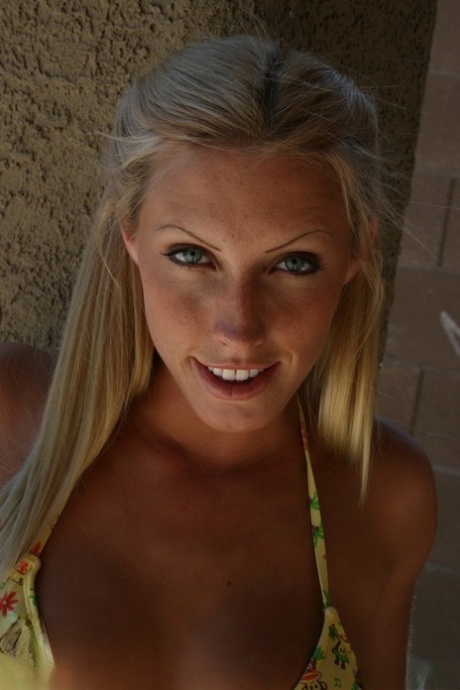 Blonde amateur holds her ass while showing her landing strip pussy