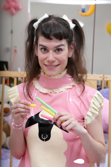 Diaper loving female is attended to by her latex attired lesbian lover