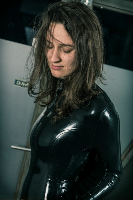 Brunette chick Ropemarks shows her bare ass while restrained in latex attire