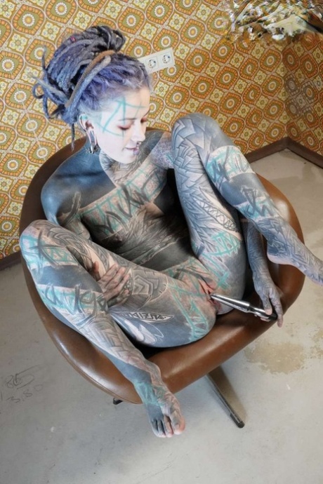 Tattooed girl Anuskatzz pleasures her pussy with a sex machine in her ass