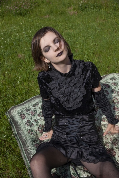 Gothic beauty Lady Phanthom stripping  spreading her furry pussy outdoors