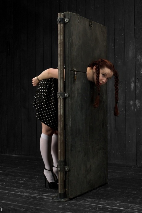 Teen AnnaBelle Lee gets humiliated while being trapped in a standing stock