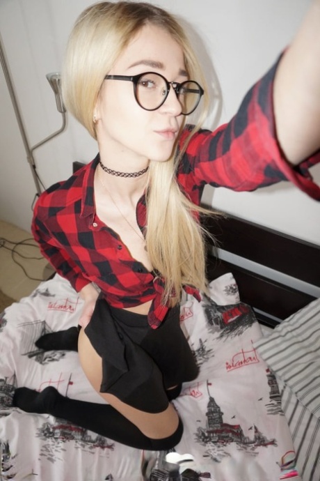 Blonde young amateur in glasses sheds her clothes and takes sexy selfies