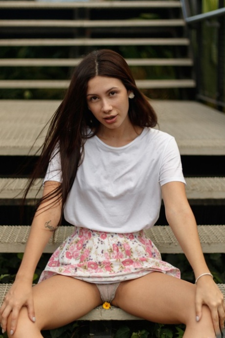 Sexy brunette babe Paloma Andaquies flashes an upskirt in panties