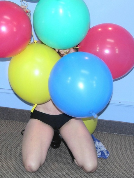 MILF Samantha Charles strips to her black boots and plays with balloons