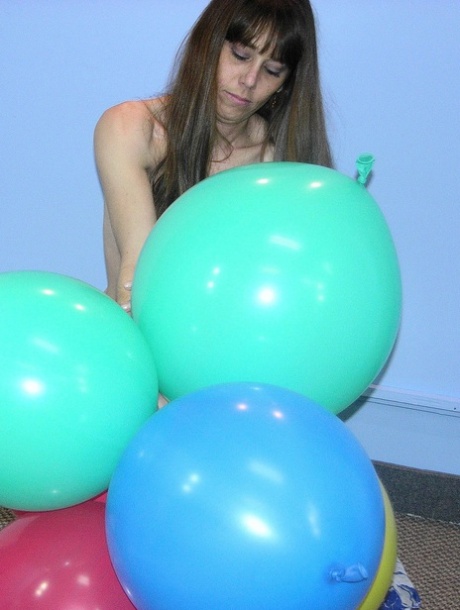 MILF Samantha Charles strips to her black boots and plays with balloons