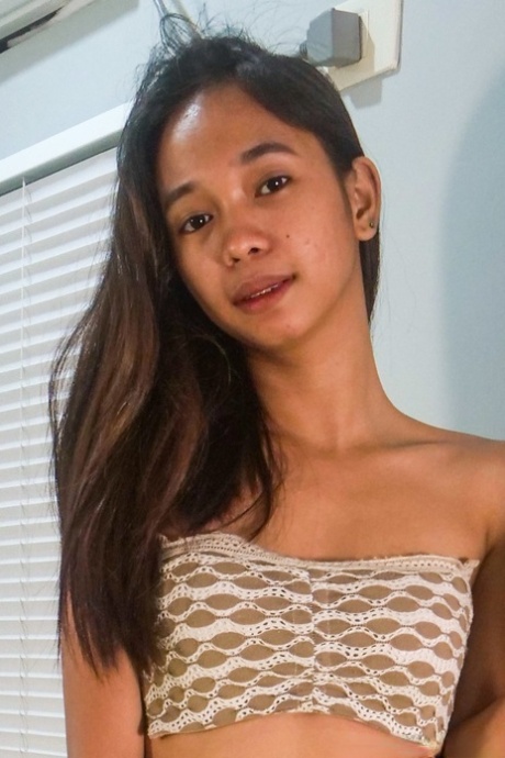 Sweet Asian teen Lexi Barrera doffs her clothes and poses butt naked