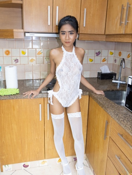 Slender Asian teen Som unveils her cute boobs and poses in stockings